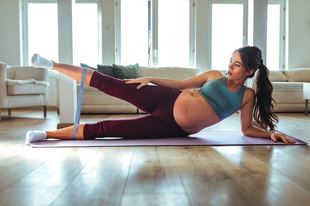 Pregnant woman doing yoga at home