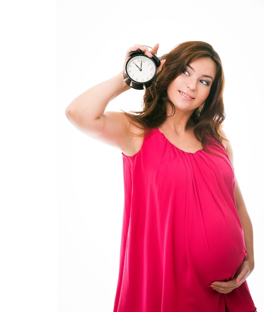 Pregnant woman in a dress on a white background