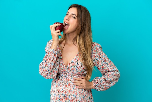 Pregnant woman eating an apple