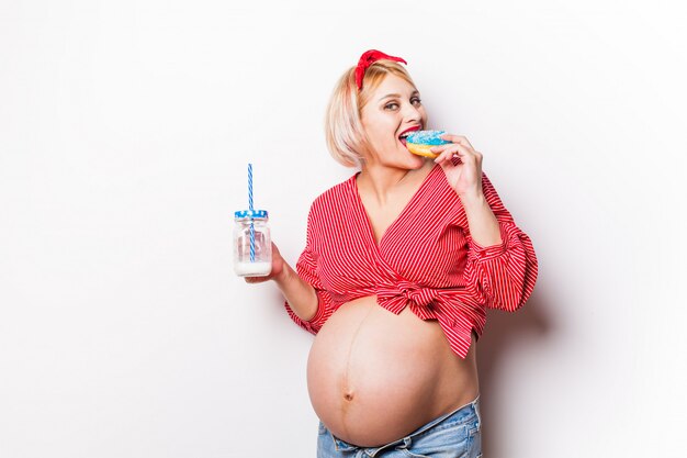 Pregnant woman eating a doughnut