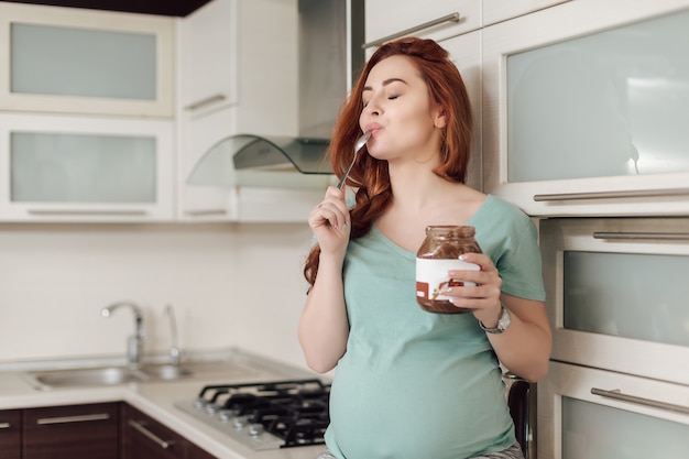 Pregnant woman enjoying eating chocolate