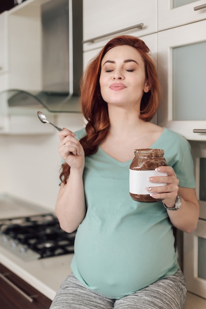 Pregnant woman enjoying eating chocolate