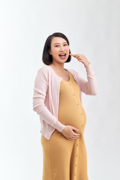 Pregnant woman enjoys eating grains bread