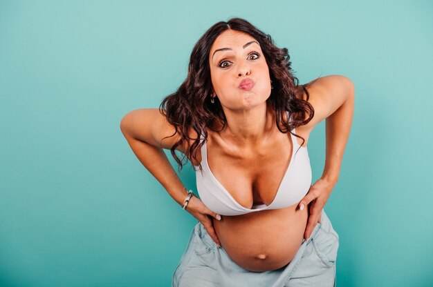 Pregnant woman expecting a child caresses her belly