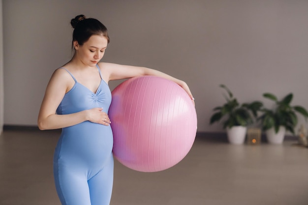 Pregnant woman during fitness classes with a fitball