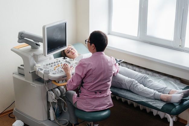 A pregnant woman gets an ultrasound of her abdomen at the clinic. Medical examination