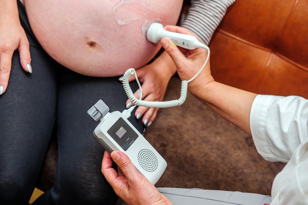 Pregnant woman getting ultrasound from doctor