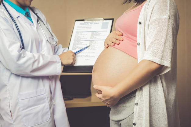 Pregnant Woman and Gynecologist Doctor at Hospital