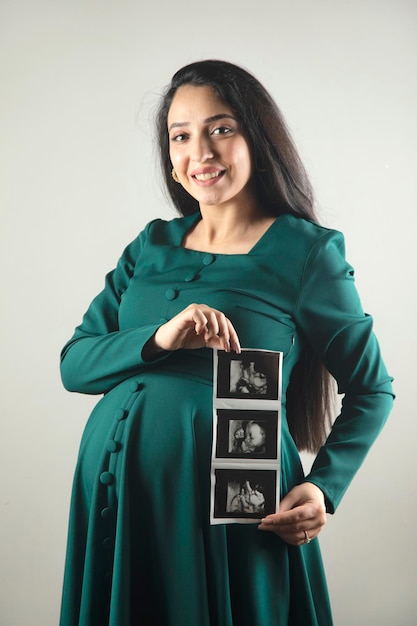 Pregnant woman hand ultrasound picture of baby