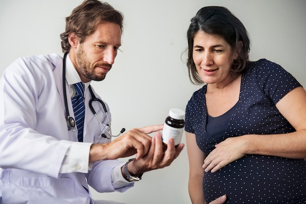 Pregnant woman having fetal monitoring by doctor