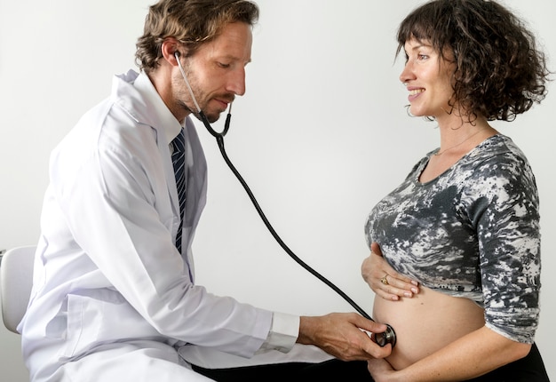 Pregnant woman having fetal monitoring by doctor