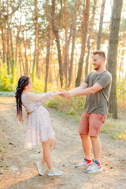 Pregnant woman and her husband in the forest