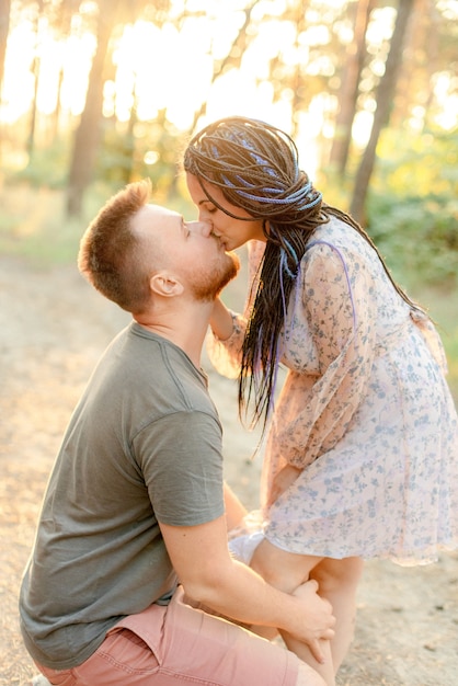 Pregnant woman and her husband in the forest