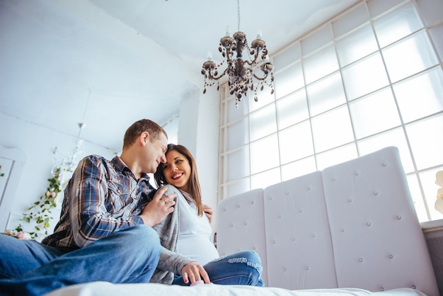 Pregnant woman and her husband holding booties