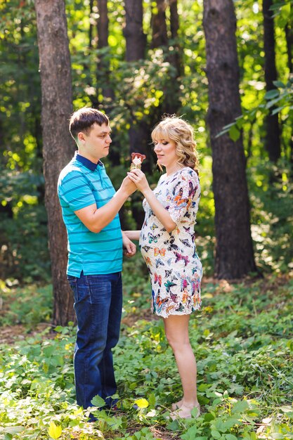 Pregnant woman and her husband outdoors