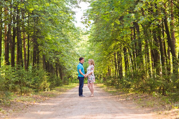 Pregnant woman and her husband outdoors