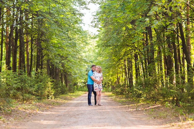 Pregnant woman and her husband outdoors