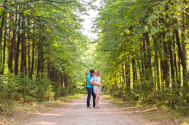 Pregnant woman and her husband outdoors