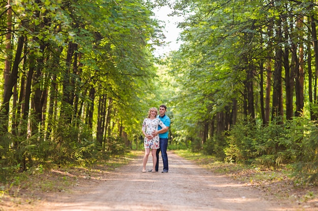 Pregnant woman and her husband outdoors