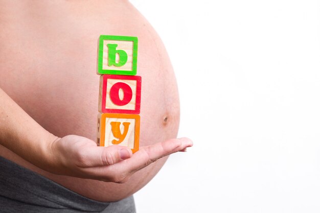 Pregnant woman holding boy word