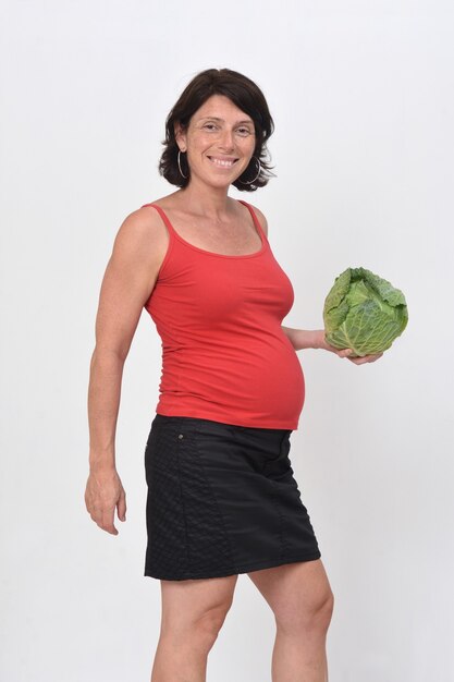 Pregnant woman holding cabbage