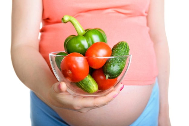 Pregnant woman holding a fresh vegetables