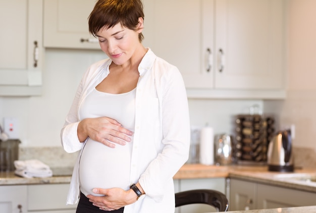 Pregnant woman holding her bump