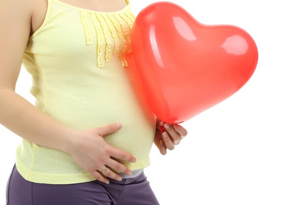 Pregnant woman holding red balloon isolated on white