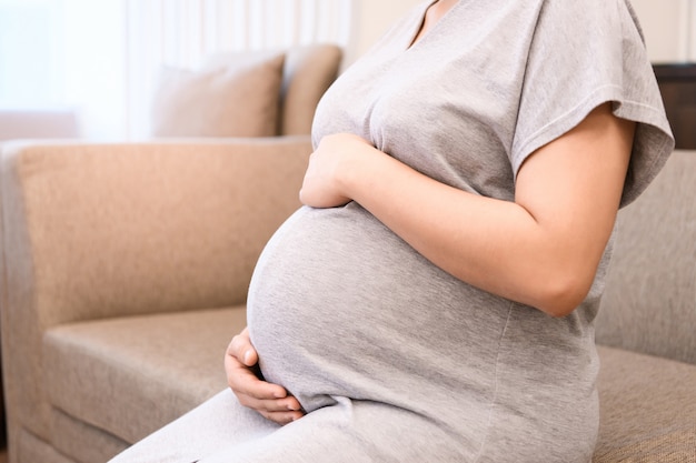 Pregnant woman holds her belly