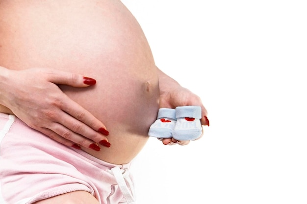 A pregnant woman holds a pill bottle with the word pill on it.