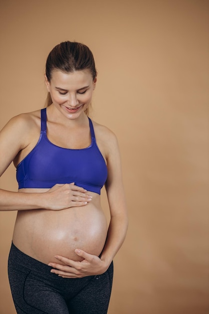 Pregnant woman hugging her belly