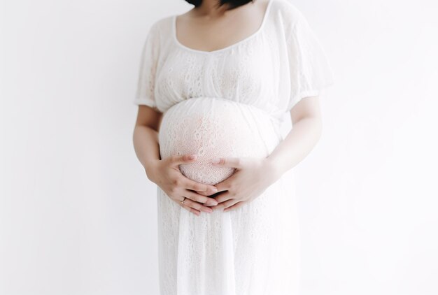 Photo pregnant woman hugging her tummy on a white background