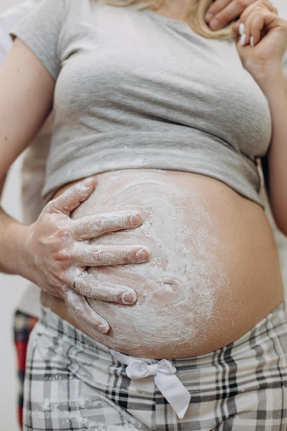 Pregnant woman husband hug hand trace flour