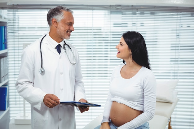 Pregnant woman interacting with doctor in clinic