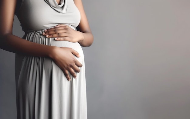 A pregnant woman is holding her stomach.