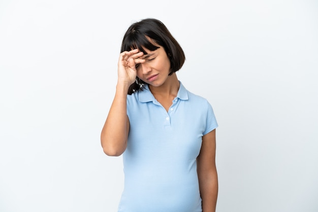 Pregnant woman over isolated white wall with tired and sick expression