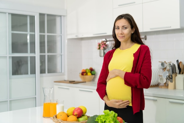 A pregnant woman in kitchen