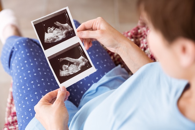pregnant woman looking at ultrasound scans