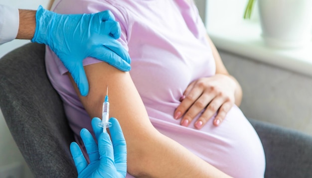 A pregnant woman makes a vaccination Selective focus