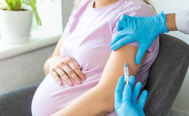 A pregnant woman makes a vaccination Selective focus