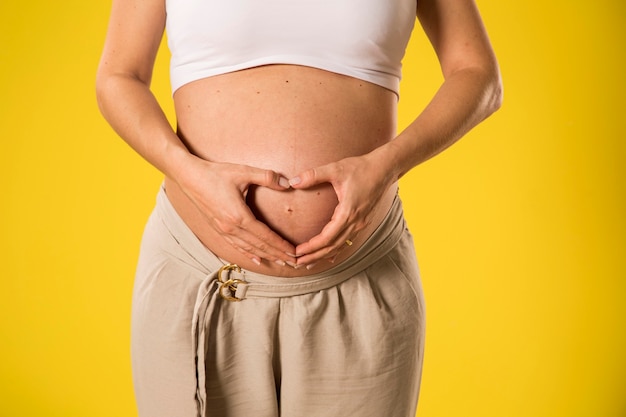 Pregnant woman making heart with her hands