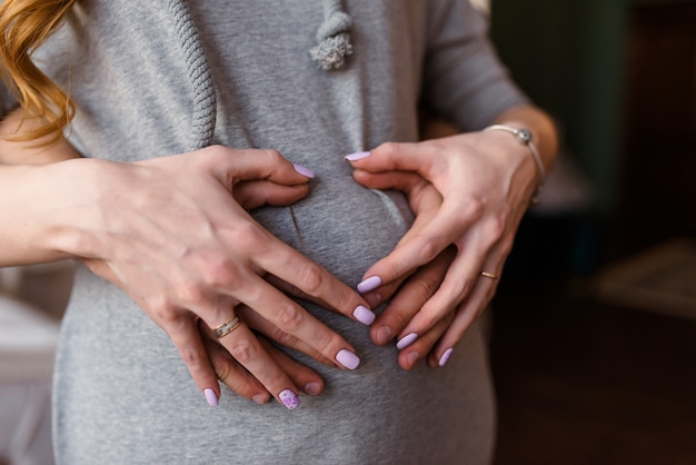 A pregnant woman and a man holding his stomach.