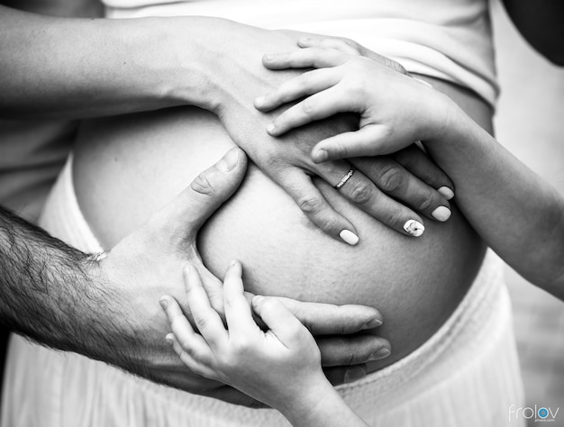 A pregnant woman and a man holding his stomach