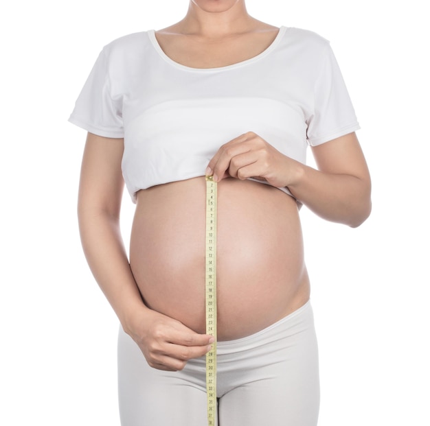 Pregnant woman measuring belly Isolated on white background