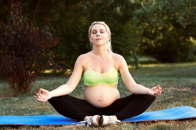 Pregnant woman meditating outdoor