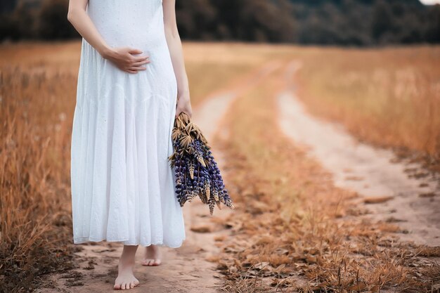 Pregnant woman in nature for a walk in the autumn