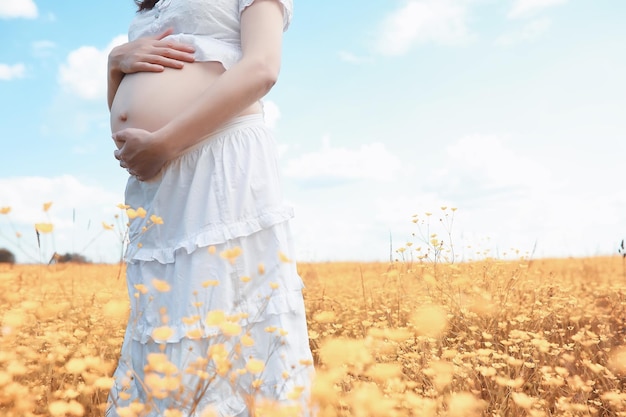 Pregnant woman in nature for a walk in the autumn