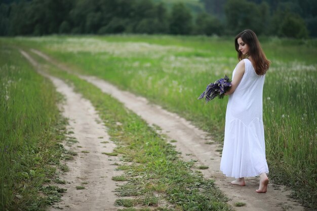 Pregnant woman in nature for a walk in the summer