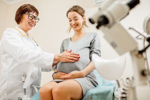 Pregnant woman patient with a senior gynecologist during the consultation in the gynecological office