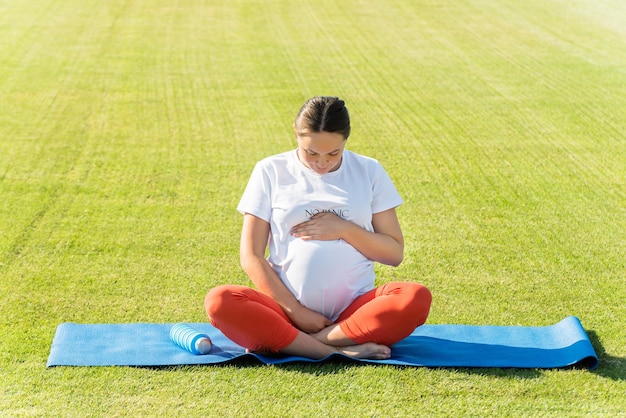 pregnant woman performs various yoga asanas